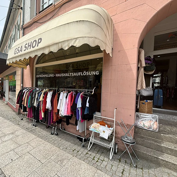 Außenansicht Laden mit Schaufenster und einer Kleidungsstange davor